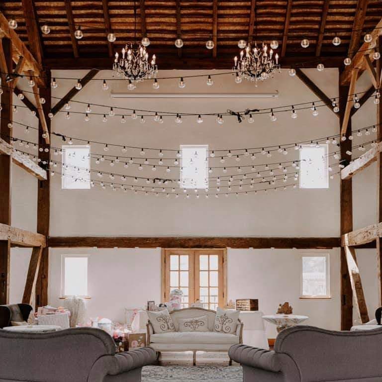 Lounge seating beneath timber beams in a barn loft